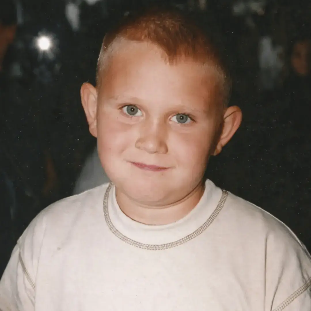 Me as a kid in an indoor portrait wearing a light sweater